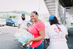 Cane Bay Cares distributes water at the Boys and Girls Club in Frederiksted in the aftermath of Hurricane Maria. Photo Credit: http://nicolecanegata.com/